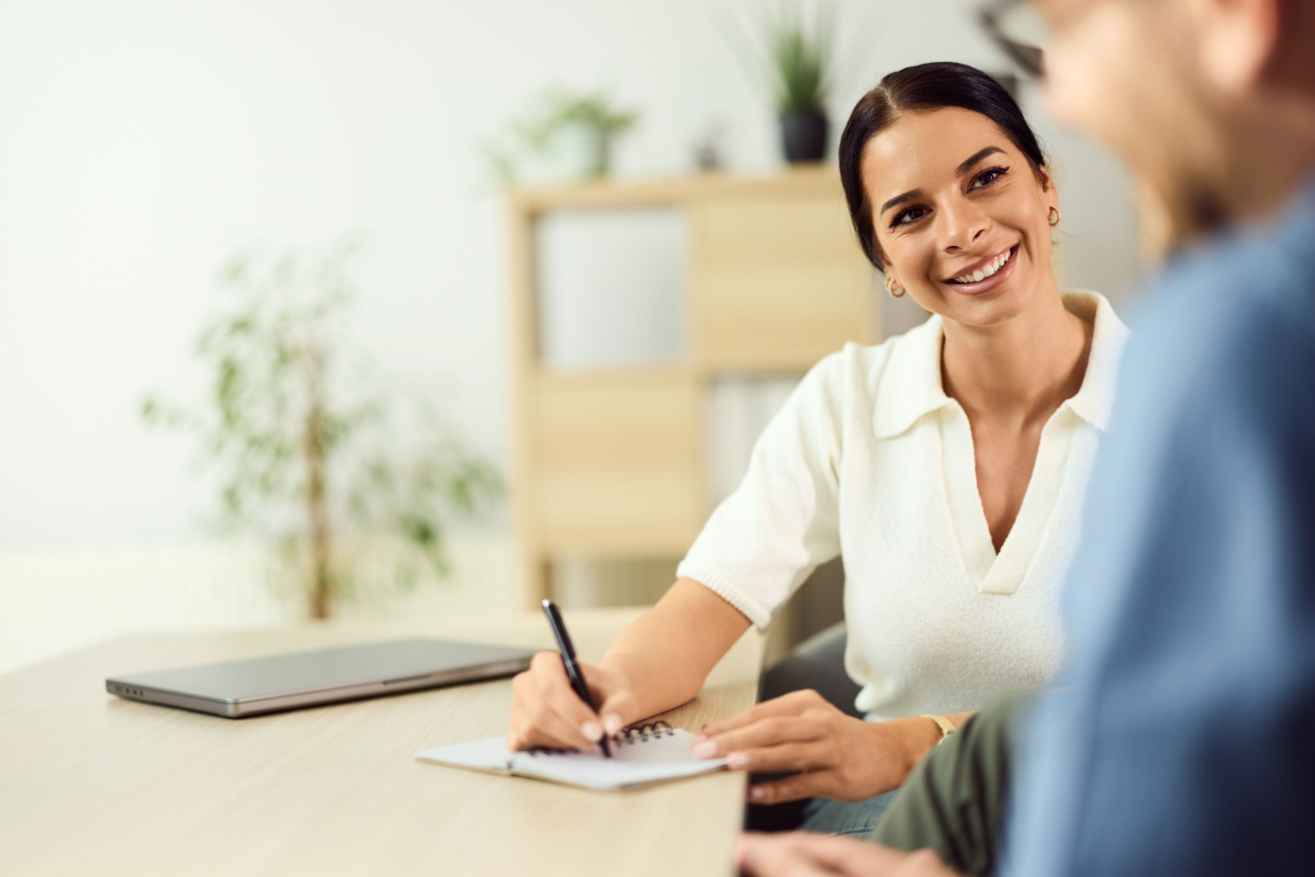 Professional Woman Smiling During a Business Consultation in a Modern Office